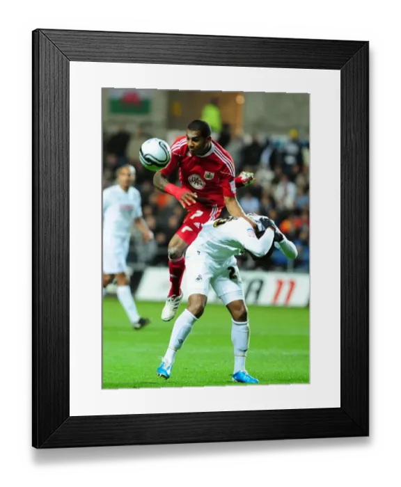 Framed Print : Battling for Supremacy: Marvin Elliott vs. Kemy Agustien in Swansea City vs. Bristol City Championship Clash (10 / 11 / 2010) Framed Print : Battling for Supremacy: Marvin Elliott vs. Kemy Agustien in Swansea City vs. Bristol City Championship Clash (10 / 11 / 2010)
