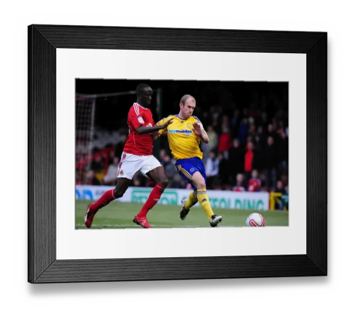 Framed Print : Adomah vs Roberts: Battle for the Ball in Bristol City vs Derby County Championship Clash, 11 / 12 / 2010