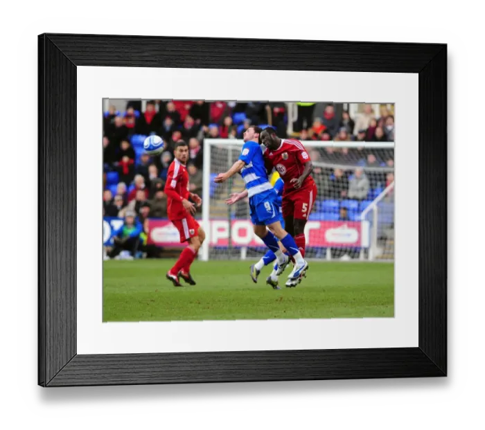 Framed Print : Damion Stewart Leaps Over Shane Long: A Championship Battle at Reading's Madejski Stadium (December 2010)