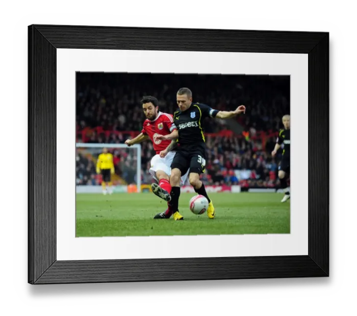 Framed Print : Battling for Supremacy: Cole Skuse vs. Craig Bellamy in the 2011 Championship Clash between Bristol City and Cardiff City
