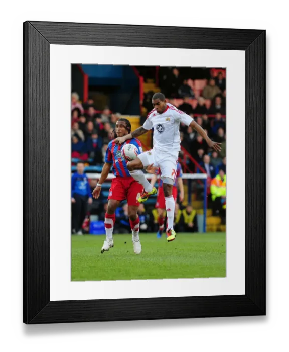 Framed Print : Battling for Supremacy: Marvin Elliott vs. Neil Danns in the 2011 Championship Clash between Crystal Palace and Bristol City