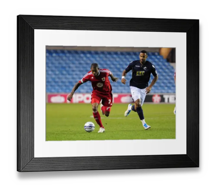 Framed Print : Bristol City's Marvin Elliott Outmaneuvers Millwall's Liam Trotter in Championship Clash, 12th April 2011