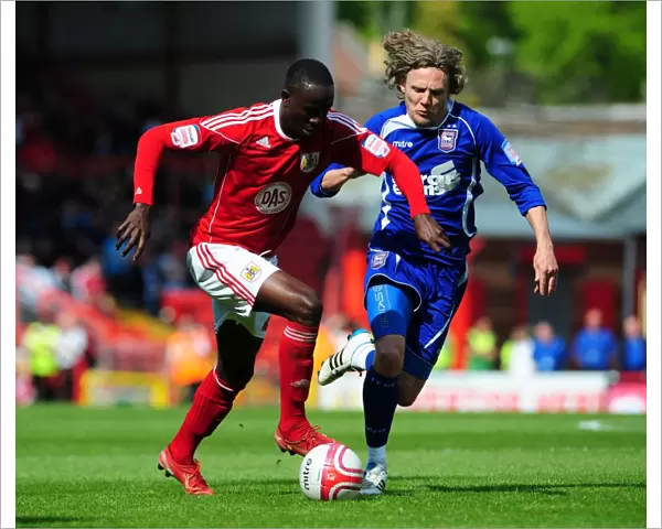 Adomah vs Bullard: Intense Battle for the Ball in the Championship Clash between Bristol City and Ipswich Town (16-04-2011)