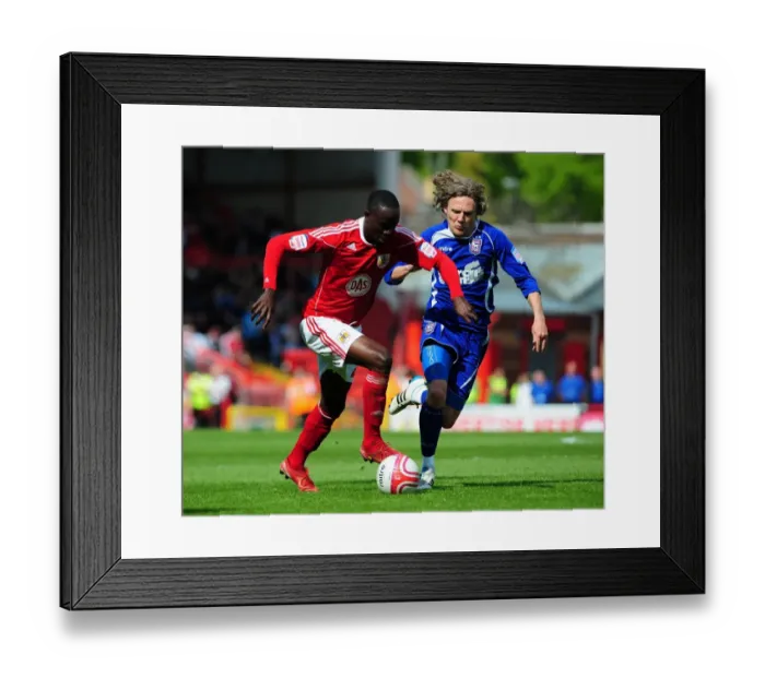 Framed Print : Adomah vs Bullard: Intense Battle for the Ball in the Championship Clash between Bristol City and Ipswich Town (16-04-2011)