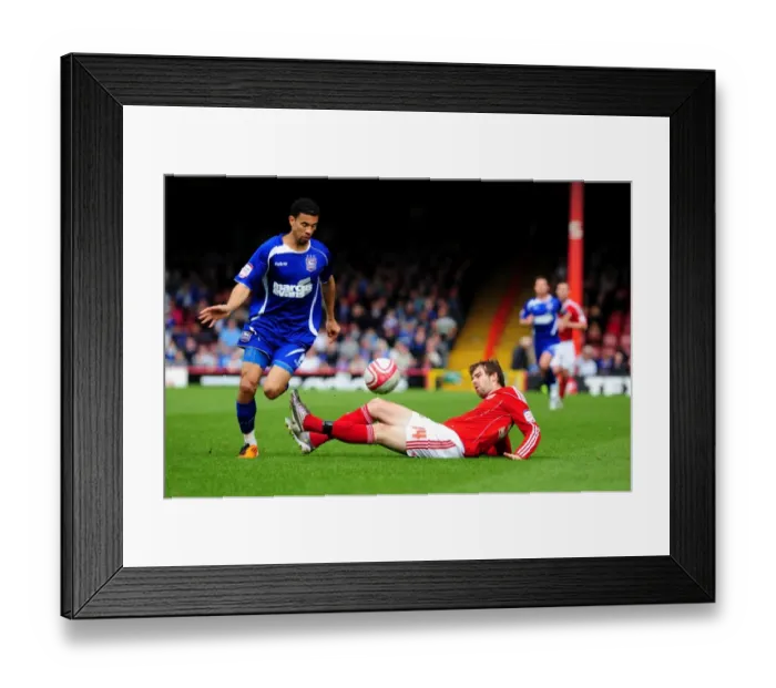 Framed Print : Battling for Supremacy: Brett Pitman vs. Carlos Edwards in the Championship Clash between Bristol City and Ipswich Town (16 / 04 / 2011)