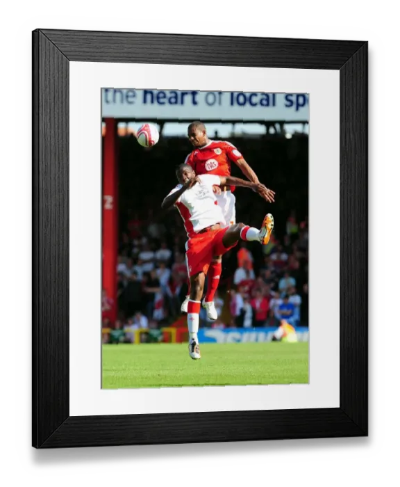 Framed Print : Marvin Elliott vs. Guy Moussi: Aerial Clash in the Championship Showdown between Bristol City and Nottingham Forest, April 2011 Framed Print : Marvin Elliott vs. Guy Moussi: Aerial Clash in the Championship Showdown between Bristol City and Nottingham Forest, April 2011
