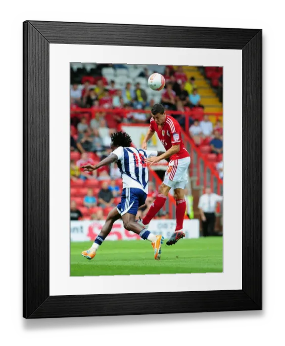 Framed Print : Bristol City's James Wilson Outjumps Somen Tchoyi in Championship Clash vs. West Brom, 2011 Framed Print : Bristol City's James Wilson Outjumps Somen Tchoyi in Championship Clash vs. West Brom, 2011