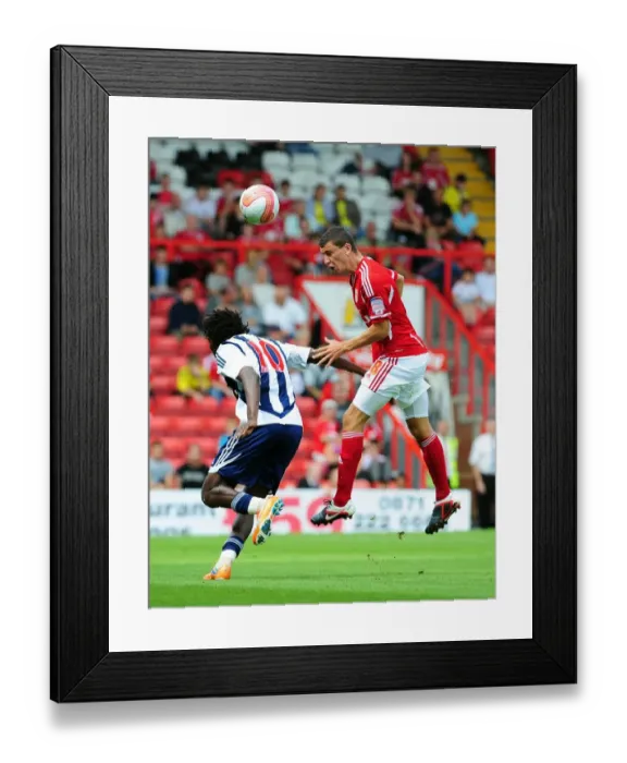 Framed Print : Bristol City's James Wilson Outmuscles Somen Tchoyi in High Ball Clash: Championship Showdown between Bristol City and West Brom, 2011 Framed Print : Bristol City's James Wilson Outmuscles Somen Tchoyi in High Ball Clash: Championship Showdown between Bristol City and West Brom, 2011