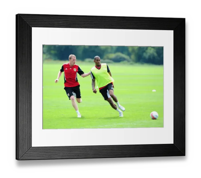Framed Print : Intense Rivalry: Marvin Elliott vs. David Clarkson - A Football Battle at Bristol City Training Framed Print : Intense Rivalry: Marvin Elliott vs. David Clarkson - A Football Battle at Bristol City Training