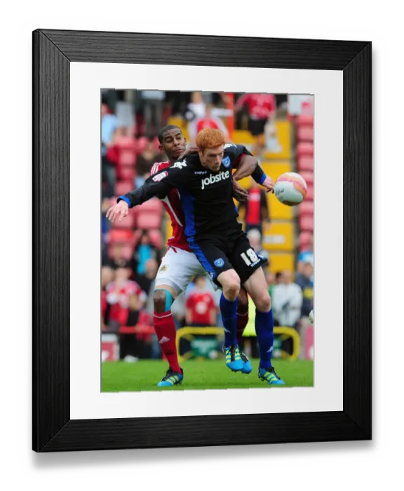 Framed Print : Bristol City vs. Portsmouth: Intense Battle Between Marvin Elliott and Dave Kitson in the 2008-09 Championship Match