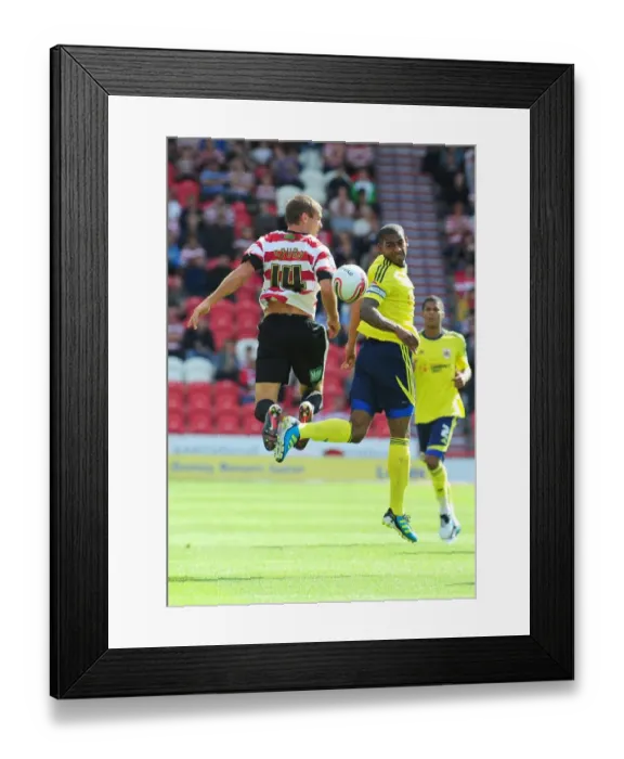 Framed Print : Battling for Supremacy: Marvin Elliott vs. Tommy Spurr in Doncaster Rovers vs. Bristol City (League Cup, 2011)