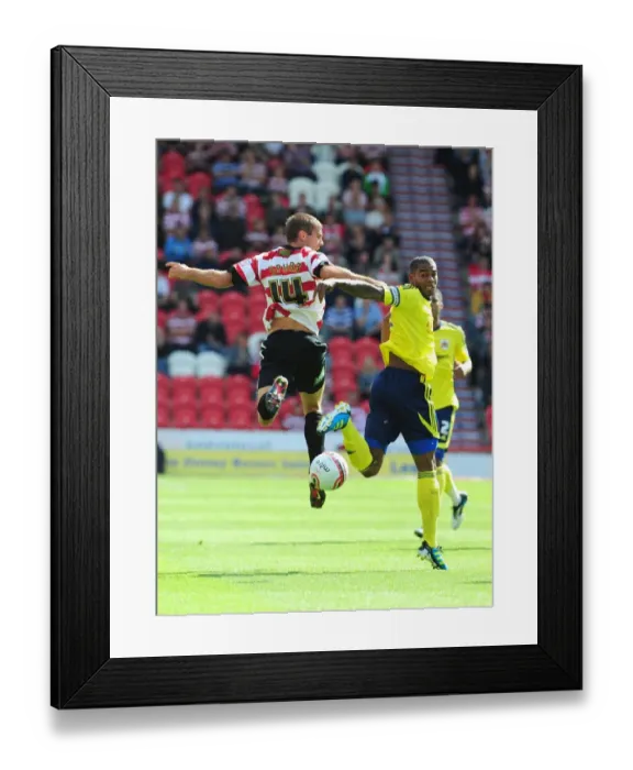Framed Print : Battling for the High Ball: Marvin Elliott vs. Tommy Spurr - Doncaster Rovers vs. Bristol City (League Cup, 2011)