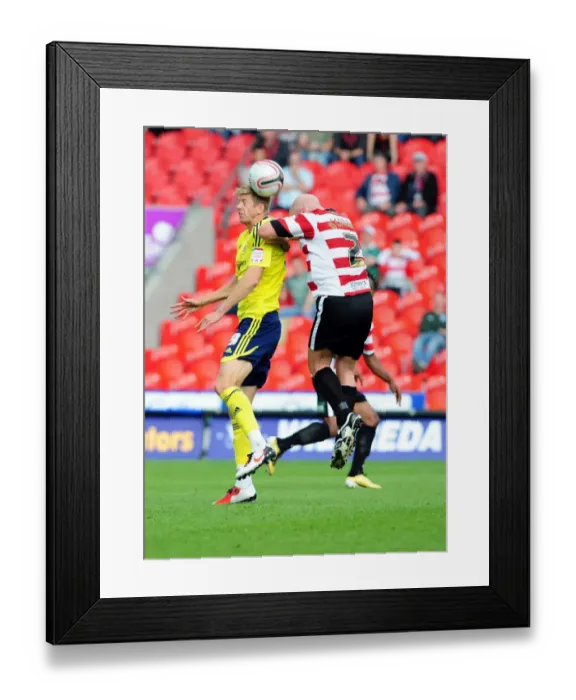 Framed Print : Nicky Maynard Flicks Ahead of James O'Connor in Doncaster Rovers vs. Bristol City League Cup Clash - 27 / 08 / 2011