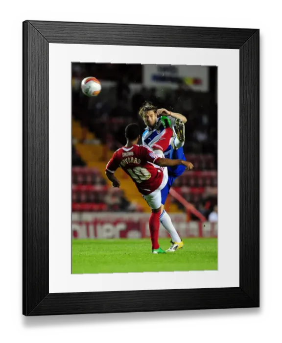 Framed Print : Bristol City's Nicky Maynard vs. Kaspars Gorkss: Battle for the Ball in Championship Match between Bristol City and Reading (September 27, 2011)