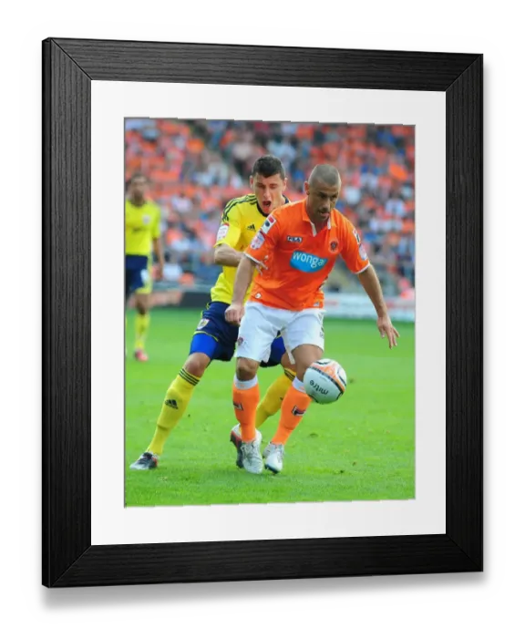 Framed Print : Bristol City's James Wilson vs. Blackpool's Kevin Phillips: Battle for the Ball in 2011 League Cup Match Framed Print : Bristol City's James Wilson vs. Blackpool's Kevin Phillips: Battle for the Ball in 2011 League Cup Match