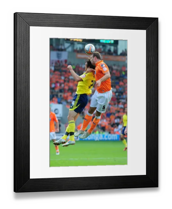 Framed Print : Ian Evatt Wins the Ball Over Brett Pitman in Blackpool vs. Bristol City League Cup Clash - 01 / 10 / 2011