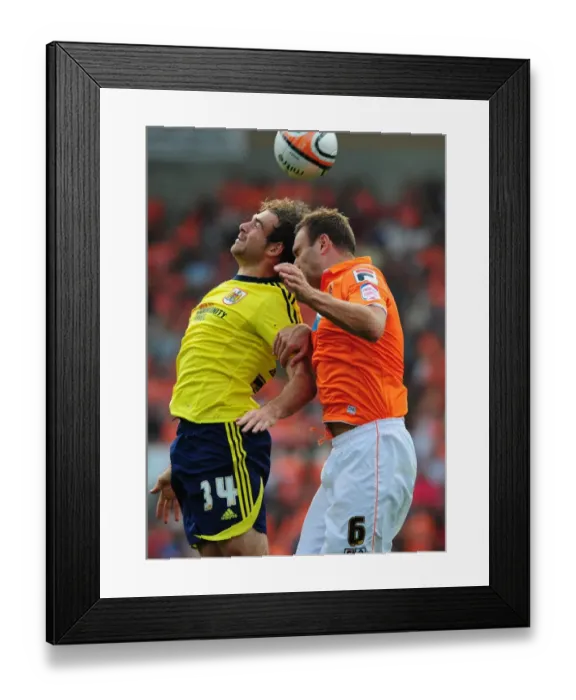 Framed Print : Ian Evatt Outjumps Brett Pitman in Blackpool's League Cup Victory over Bristol City (1st October 2011) Framed Print : Ian Evatt Outjumps Brett Pitman in Blackpool's League Cup Victory over Bristol City (1st October 2011)