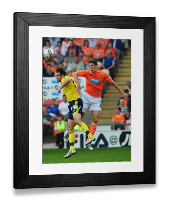 Framed Print : Craig Cathart Outjumps Brett Pitman: Blackpool Secures Ball in League Cup Clash vs. Bristol City (1st October 2011) Framed Print : Craig Cathart Outjumps Brett Pitman: Blackpool Secures Ball in League Cup Clash vs. Bristol City (1st October 2011)