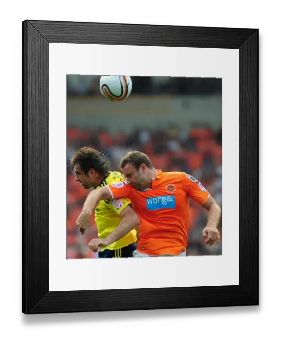 Framed Print : Ian Evatt Leaps Above Brett Pitman: Blackpool's League Cup Upset over Bristol City (1st October 2011)