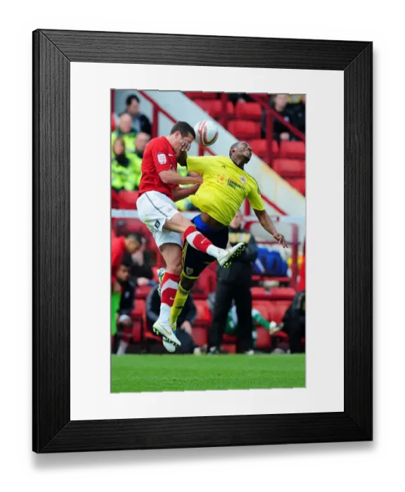 Framed Print : Battling for Supremacy: Marvin Elliott vs. Nathan Doyle in Championship Clash between Barnsley and Bristol City Framed Print : Battling for Supremacy: Marvin Elliott vs. Nathan Doyle in Championship Clash between Barnsley and Bristol City