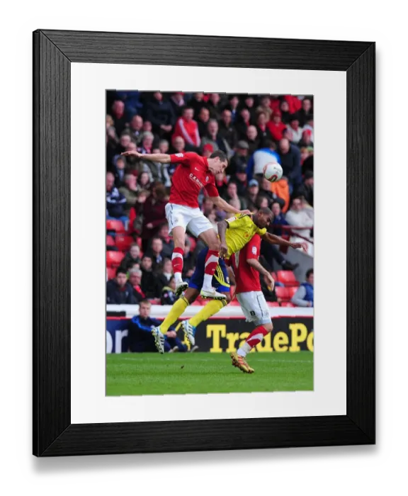 Framed Print : Barnsley vs. Bristol City: Intense Battle for the High Ball in Championship Match, October 2011