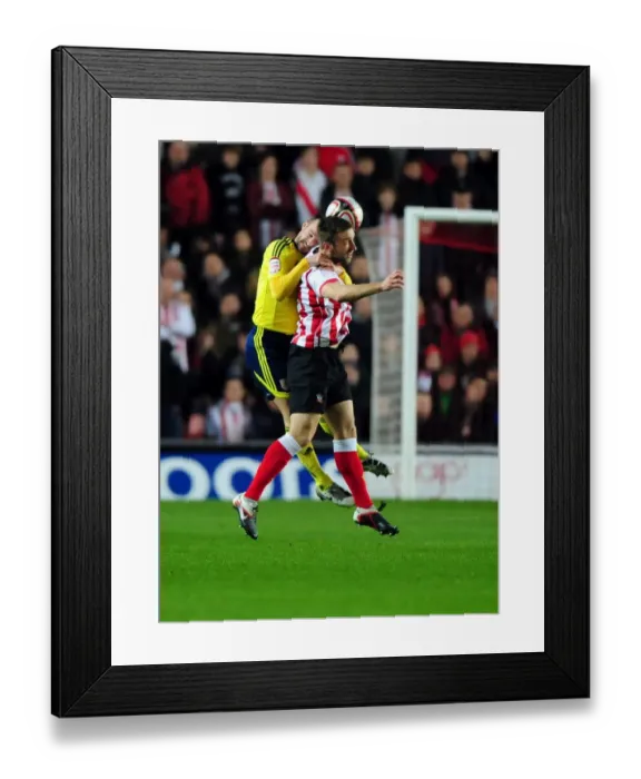 Framed Print : Bristol City's Louis Carey vs. Rickie Lambert: A Battle for Supremacy in the Championship Clash between Southampton and Bristol City (December 30, 2011)