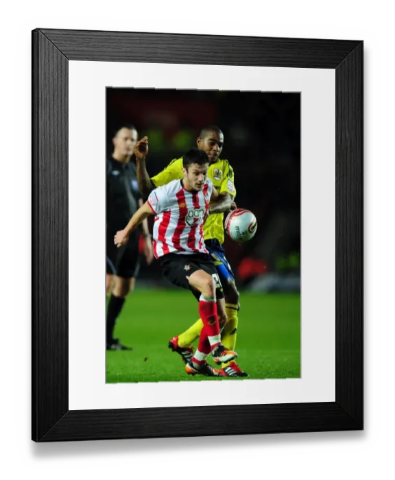 Framed Print : Marvin Elliott vs. Adam Lallana: Battle for the Ball in Southampton v Bristol City Championship Clash (December 2011) Framed Print : Marvin Elliott vs. Adam Lallana: Battle for the Ball in Southampton v Bristol City Championship Clash (December 2011)