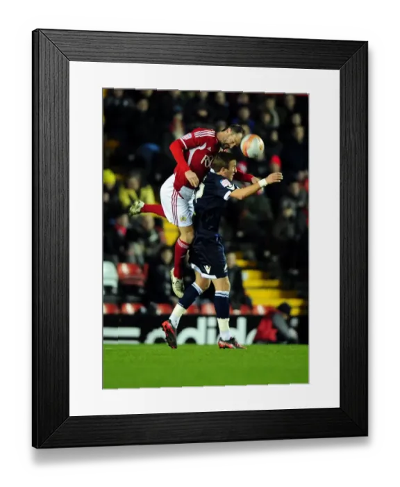 Framed Print : Bristol City's Louis Carey vs. Harry Kane: A Battle for the High Ball in the 2012 Championship Match between Bristol City and Millwall Framed Print : Bristol City's Louis Carey vs. Harry Kane: A Battle for the High Ball in the 2012 Championship Match between Bristol City and Millwall