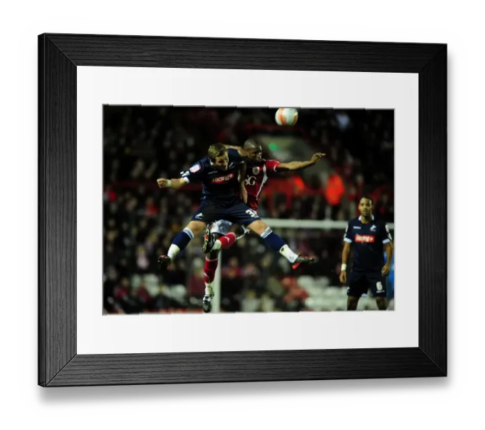 Framed Print : Bristol City's Kalifa Cisse vs. Harry Kane: A Battle for the High Ball in the 2012 Championship Match between Bristol City and Millwall