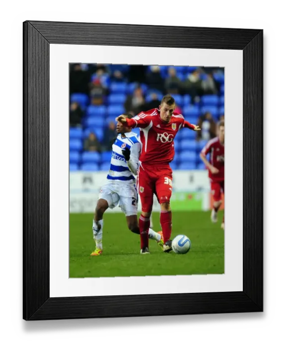 Framed Print : Chris Wood vs Shaun Cummings: Battle for the Ball in Reading v Bristol City Championship Clash - 28 / 01 / 2012