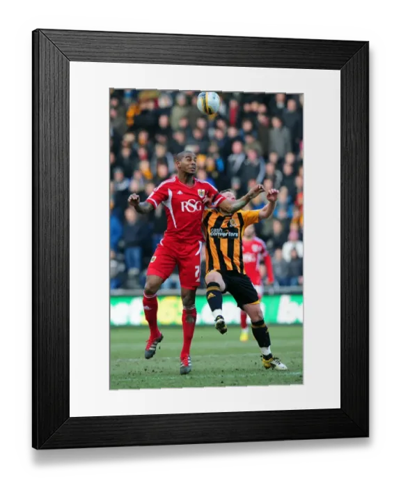 Framed Print : Battling for Supremacy: Marvin Elliott vs. Paul McKenna in Hull City vs. Bristol City Championship Clash - 11 / 02 / 2012