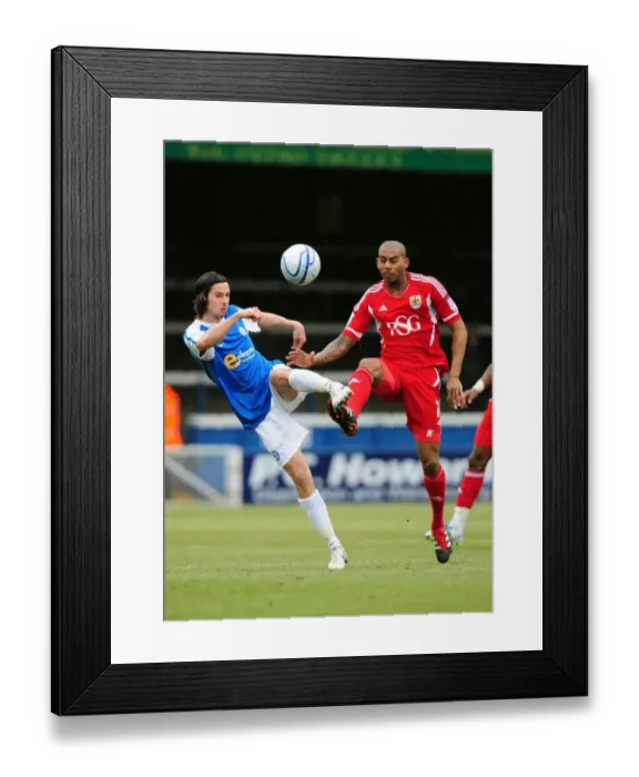 Framed Print : Battling for Supremacy: Marvin Elliott vs. George Boyd in Peterborough United vs. Bristol City Football Match, 2012