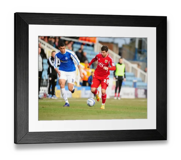 Framed Print : Bristol City's Richard Foster Outmaneuvers Peterborough's Matthew Briggs During the 2012 Match