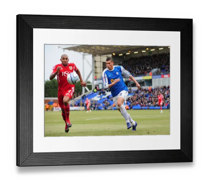 Framed Print : Race for the Ball: Briggs vs. Elliott in Peterborough United vs. Bristol City Football Match Framed Print : Race for the Ball: Briggs vs. Elliott in Peterborough United vs. Bristol City Football Match
