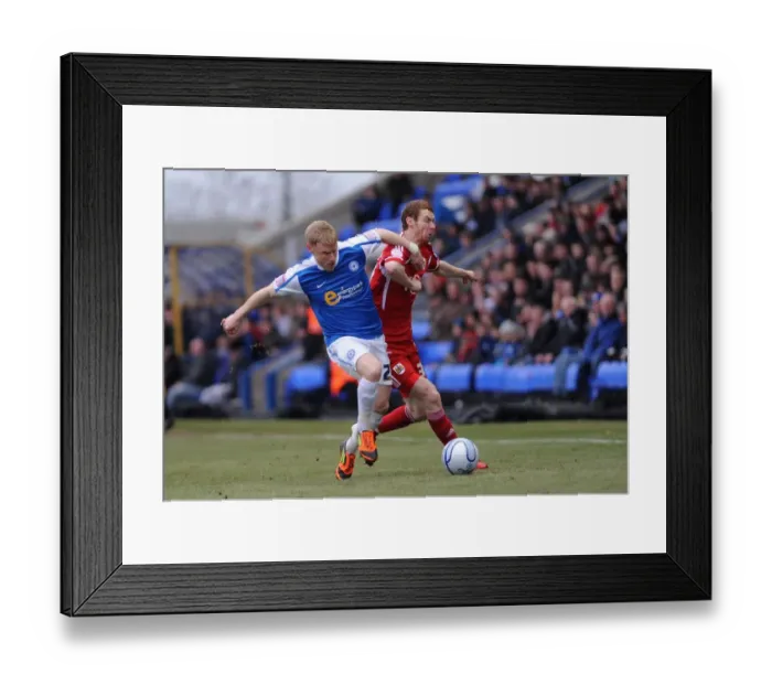 Framed Print : Battling for Supremacy: Pearson vs. Taylor - A Football Rivalry Unfolds at London Road Stadium