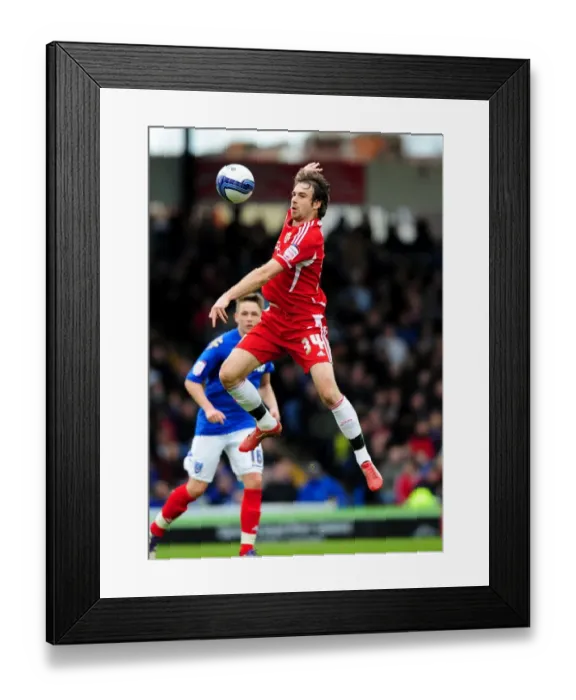 Framed Print : Brett Pitman Soars High: Portsmouth vs. Bristol City Football Rivalry, 17-03-2012