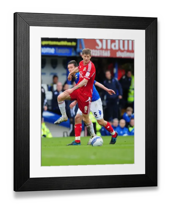 Framed Print : Bristol City's Jon Stead vs Portsmouth's Jason Pearce: Battle for the Ball at Fratton Park, 2012