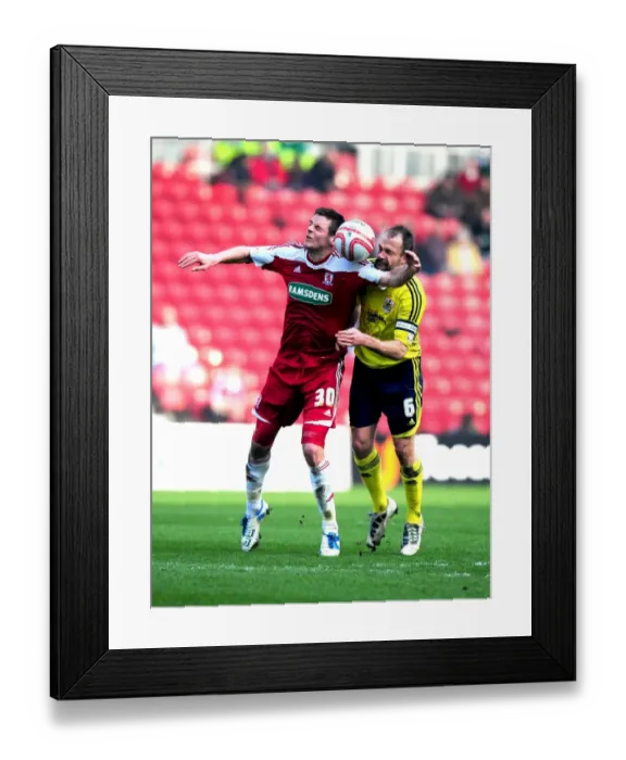 Framed Print : Bristol City's Louis Carey vs. Middlesbrough's Lukas Jutkiewicz: A Battle for Supremacy in the Riverside Stadium Air (Middlesbrough v Bristol City, 2012)