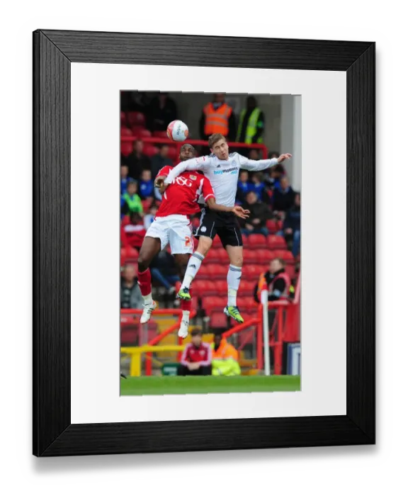 Framed Print : Intense Aerial Clash: Cisse vs. Davies at Ashton Gate