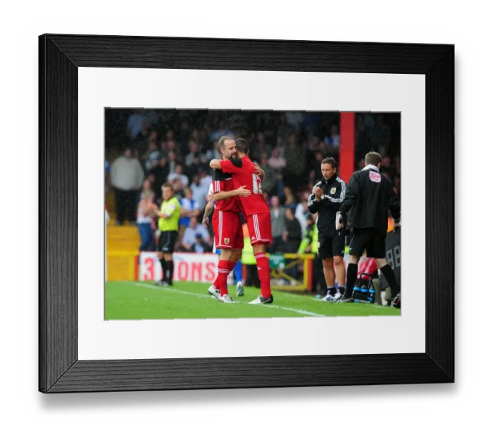 Framed Print : Louis Carey's Embrace: A Heartwarming Moment at the Louis Carey Testimonial, Bristol City v Bristol Rovers, August 2012 Framed Print : Louis Carey's Embrace: A Heartwarming Moment at the Louis Carey Testimonial, Bristol City v Bristol Rovers, August 2012