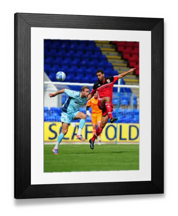 Framed Print : Bristol City's Lewin Nyatanga Battles for the High Ball in Pre-Season Friendly against St Johnstone