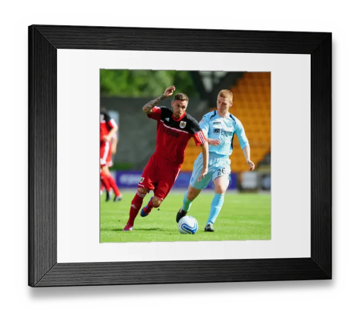 Framed Print : Battling for Supremacy: Paul Anderson vs. Liam Caddis in the Pre-Season Clash between St Johnstone and Bristol City Framed Print : Battling for Supremacy: Paul Anderson vs. Liam Caddis in the Pre-Season Clash between St Johnstone and Bristol City