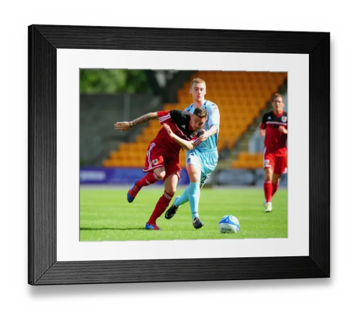 Framed Print : Battling for Control: Paul Anderson vs. Liam Caddis - Pre-Season Football Showdown