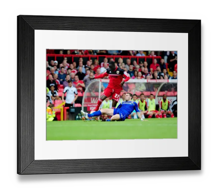 Framed Print : A Battle for Possession: Mutch vs. Adomah in the Championship Clash at Ashton Gate