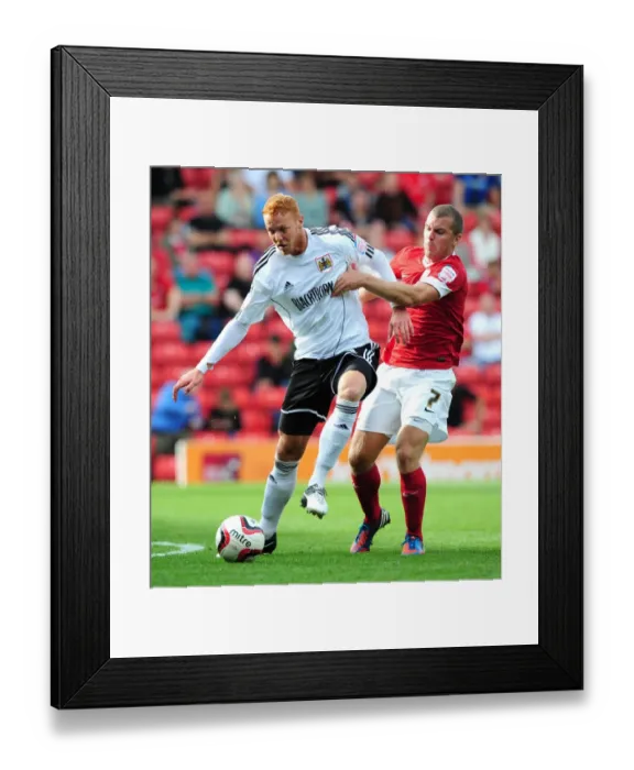 Framed Print : Championship Clash: Ryan Taylor vs Stephen Dawson at Oakwell Stadium, September 1, 2012 - A Football Battle Framed Print : Championship Clash: Ryan Taylor vs Stephen Dawson at Oakwell Stadium, September 1, 2012 - A Football Battle