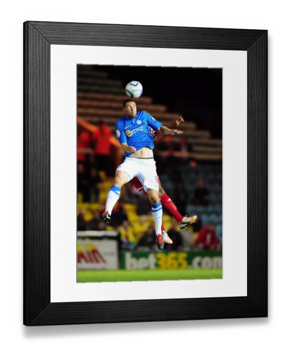 Framed Print : Battling for Supremacy: Peterborough United's Michael Bostwick vs. Marvin Elliott of Bristol City Framed Print : Battling for Supremacy: Peterborough United's Michael Bostwick vs. Marvin Elliott of Bristol City