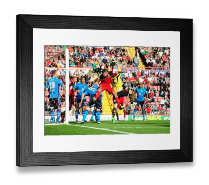 Framed Print : Bristol City vs Leeds United: Intense Aerial Battle Between James Wilson and Paddy Kenny Framed Print : Bristol City vs Leeds United: Intense Aerial Battle Between James Wilson and Paddy Kenny