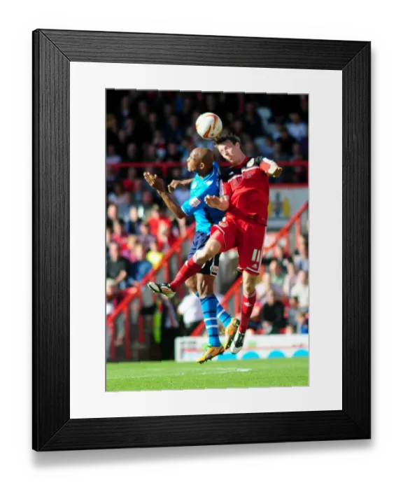 Framed Print : Bristol City's Martyn Woolford Outmuscles Rodolph Austin for the Header in Championship Clash against Leeds United Framed Print : Bristol City's Martyn Woolford Outmuscles Rodolph Austin for the Header in Championship Clash against Leeds United
