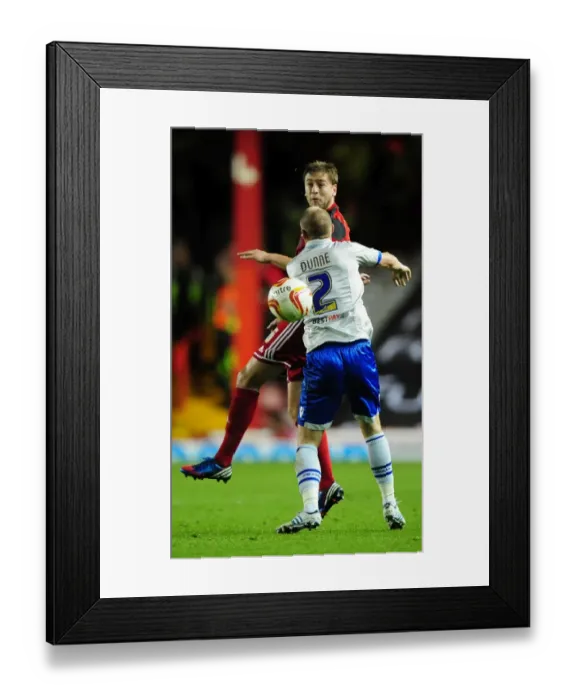 Framed Print : Bristol City's Steven Davies Battles for Header Against Millwall's Alan Dunne in Championship Match Framed Print : Bristol City's Steven Davies Battles for Header Against Millwall's Alan Dunne in Championship Match