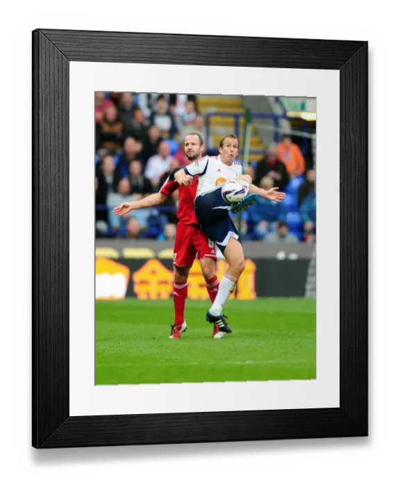 Framed Print : Battling for Supremacy: Kevin Davies vs. Louis Carey in the 2010-11 Championship Clash between Bolton Wanderers and Bristol City